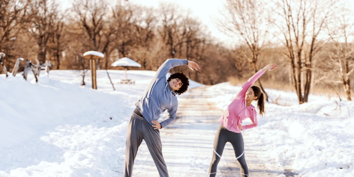Two people exercising in snow garden.